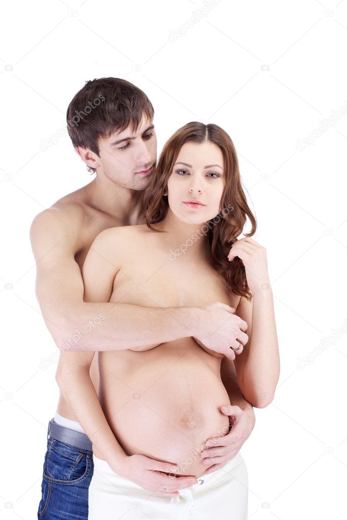 Happy sensual couple embracing with pregnant belly