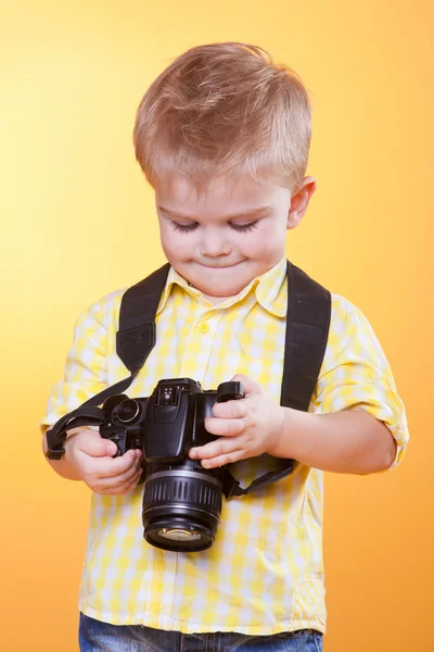 Little smiling photographer watching photo on camera — Stock Photo, Image