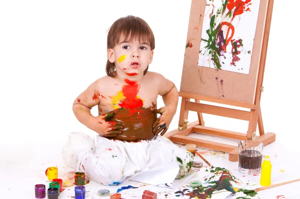 Funny child spreading paints with hands on stomach — Stock Photo, Image