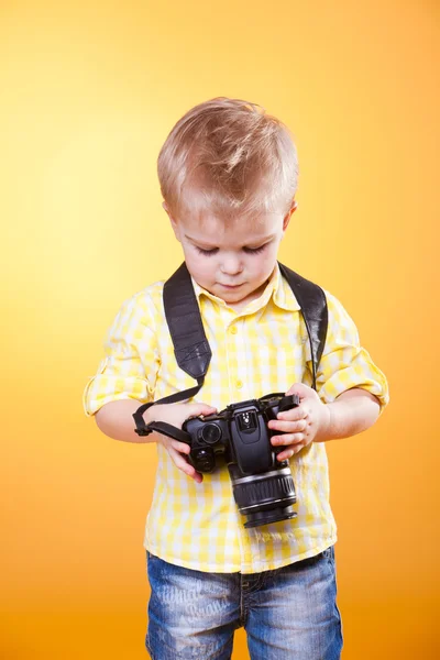 Little photographer watch photo on camera — Stock Photo, Image