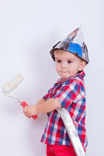 Little cute boy on ladder painting wall with roller — Stock Photo, Image