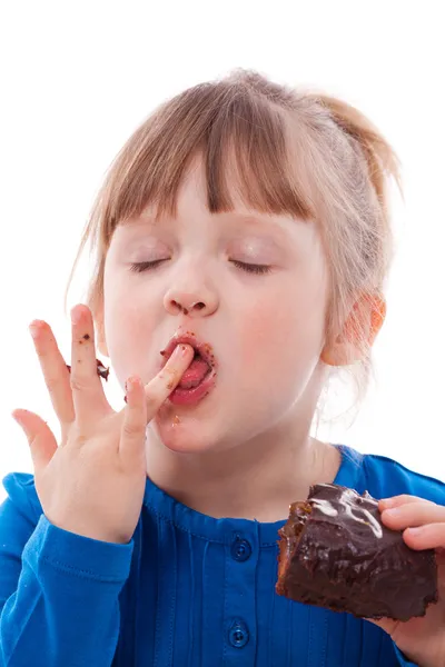 Hungry girl lick fingers dirty with cake — Stock Photo, Image