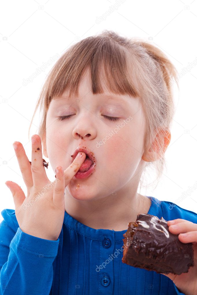 Hungry girl lick fingers dirty with cake