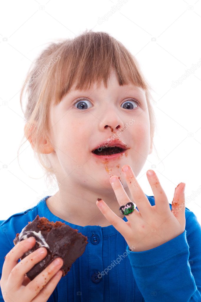 Surprised hungry girl dirty with chocolate cake
