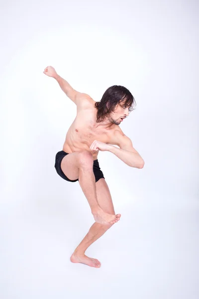 Jovem homem atraente dançando em estúdio — Fotografia de Stock