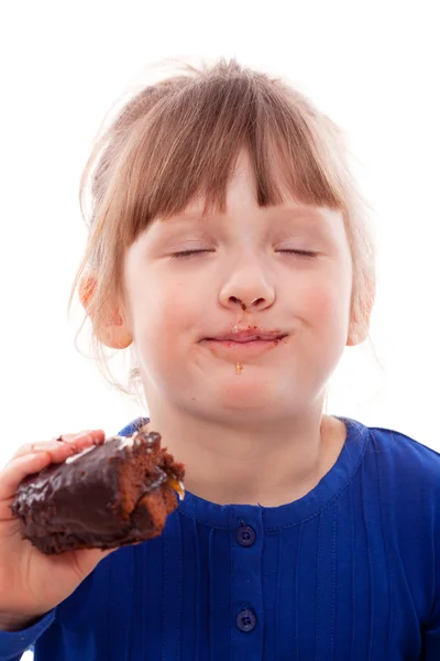 Dreaming girl with cake smiling — Stock Photo, Image