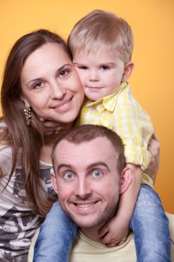 Young parents with little son on father's shoulders clipart