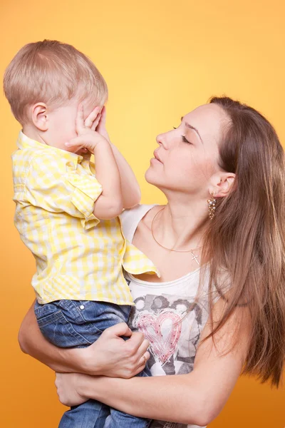 Mother holding little son hiding eyes — Stock Photo, Image