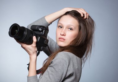 Unusual portrait of beautiful female photographer shooting clipart