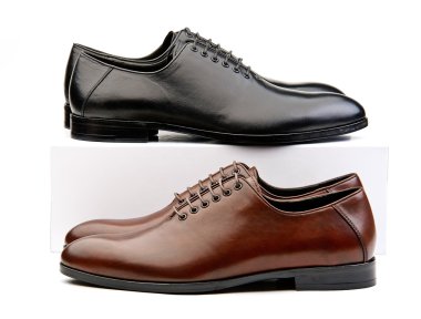 Two pairs of male classic shoes brown and black ones clipart