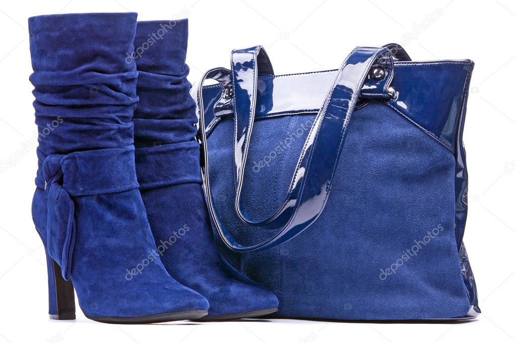 Blue female suede boots and bag on the white background