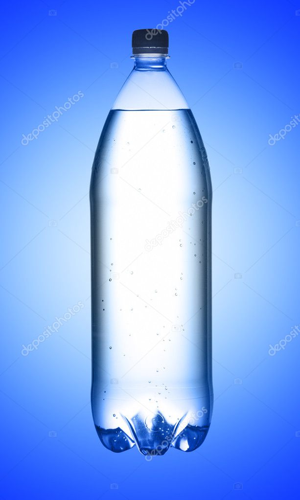 Bottle of water on blue background, studio shot. With path