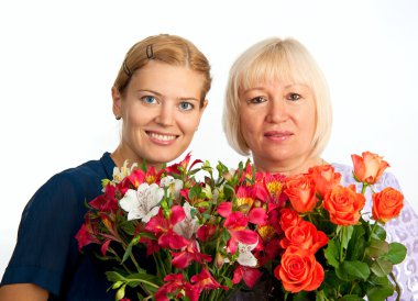 Two smiling women with flowers on white background clipart