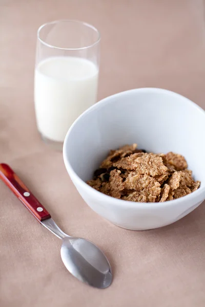 Bowl with cornflakes and cup of milk — Stock Photo, Image