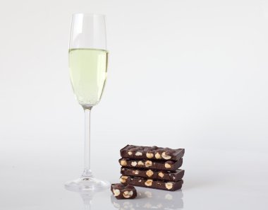 Glass of champagne and chocolate with nuts clipart