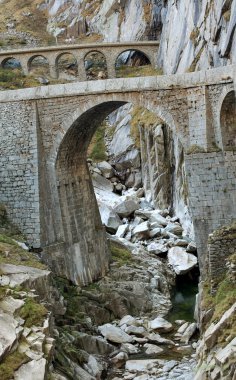 Old bridge in mountains clipart
