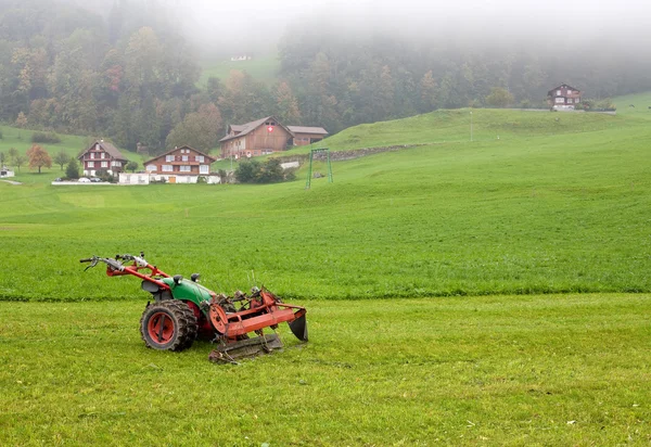 stock image Tractor standing on the mowed field