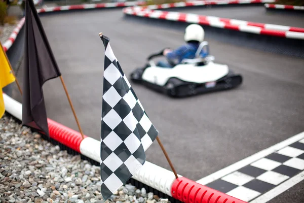 Flags and car on carting track — Stock Photo, Image