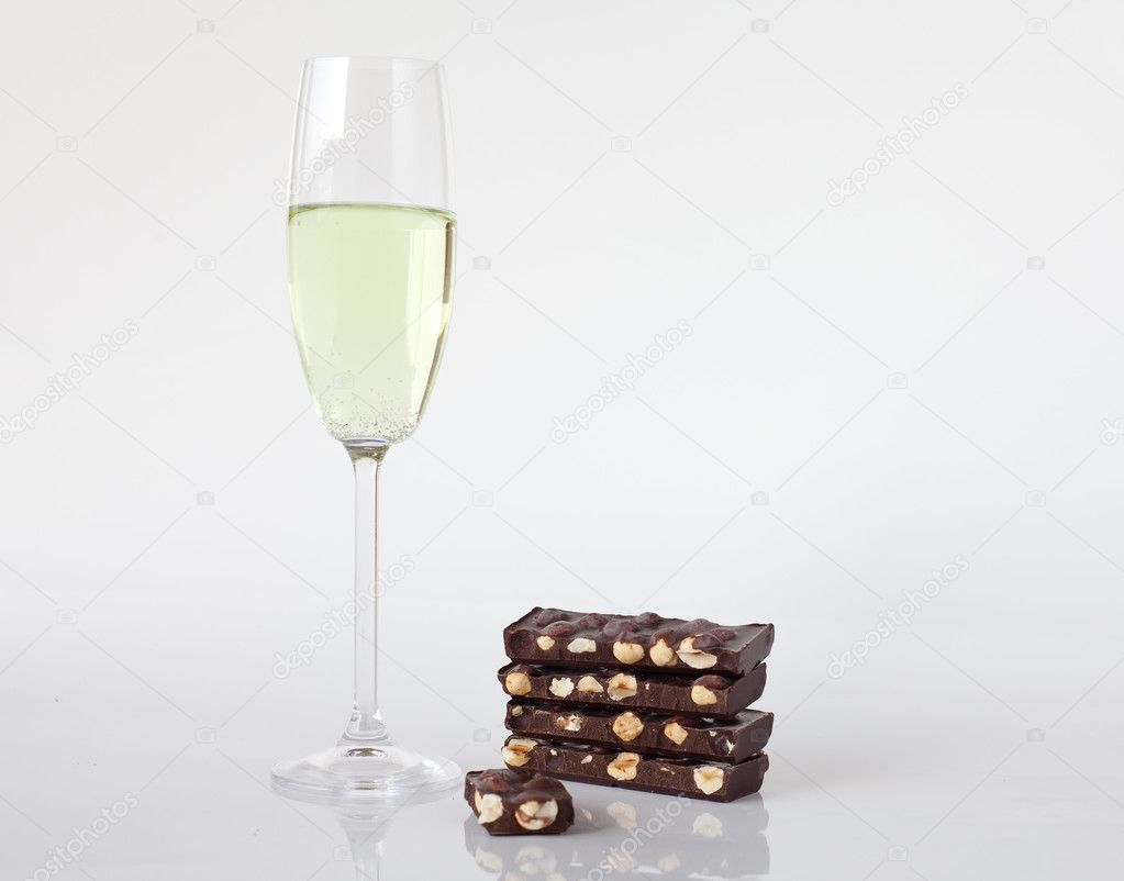 Glass of champagne and chocolate with nuts
