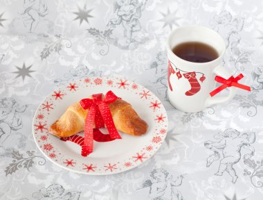 Brioche tied with a red bow on a plate in Christmas style clipart