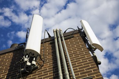 Cellular antennas installed on the building clipart