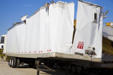 White trailer after accident against blue sky. clipart