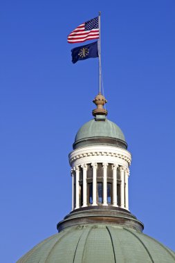 Flags on the top of State Capitol Building clipart