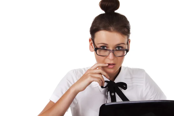 Жінка в окулярах сидить і працює на ноутбуці — стокове фото
