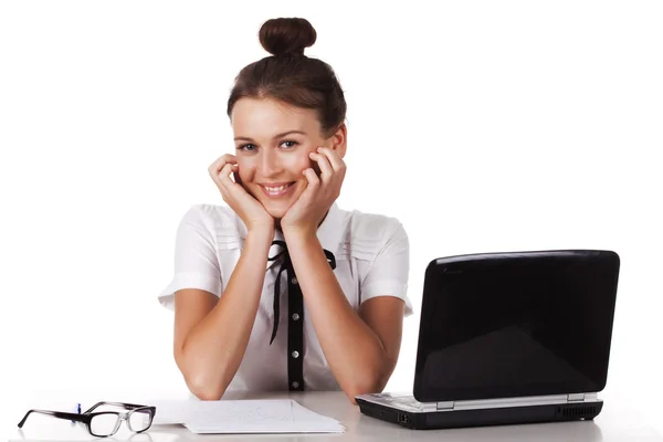 The friendly young woman sitting at your desk looks coquettishly — Stock Photo, Image