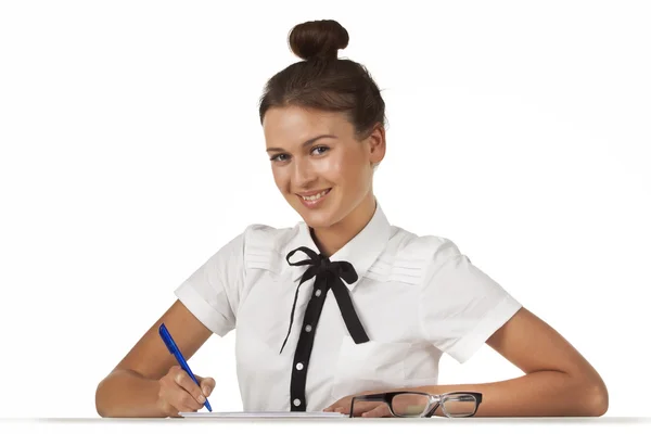 Brunette sitting at the table working with documents and a friendly smile — Stock Photo, Image