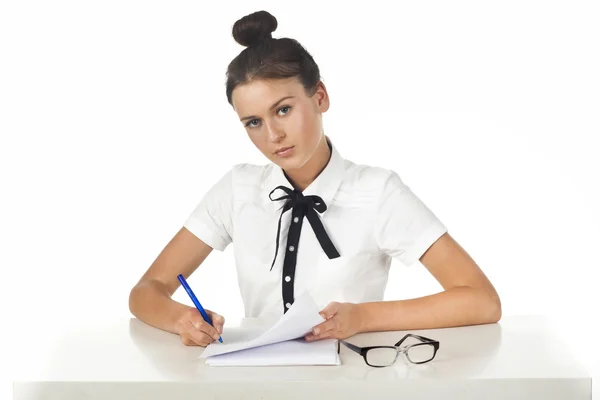 Brunette sitting at the table working with documents and a friendly smile — Stock Photo, Image