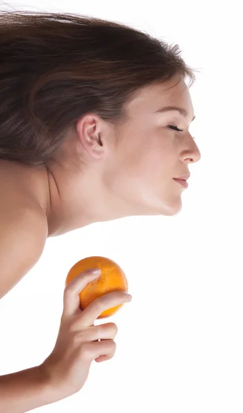 The woman reaches for the orange which holds in his hand — Stock Photo, Image