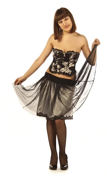 En vuxen kvinna poserar i en kjol, korsett, strumpor, skor — Stockfoto