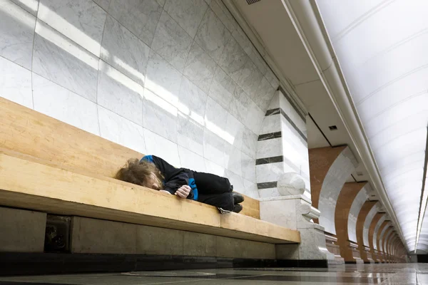 stock image Homeless man sleeping on the bench in the subway