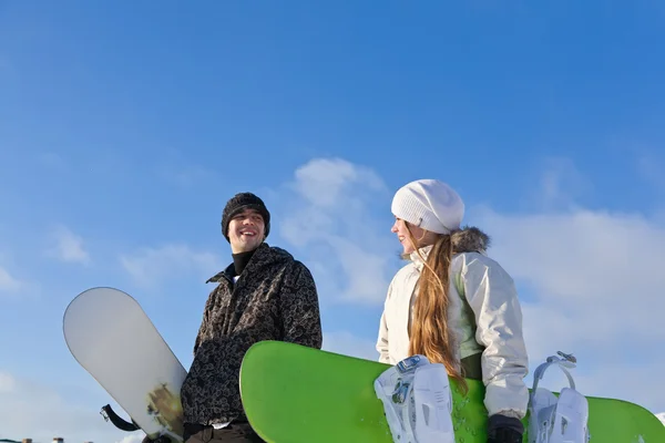 Young smiling couple with snowboards — Stock Photo, Image