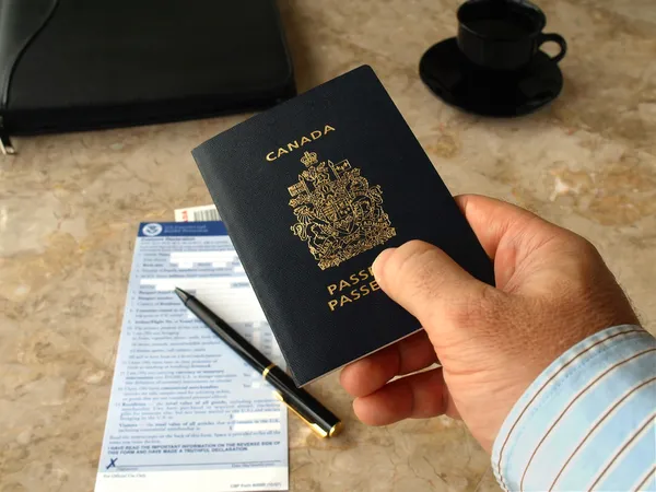 Businessman holding Canadian passport — Stock Photo, Image