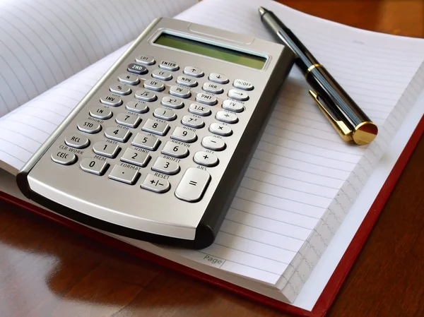 Planner with calculator and pen — Stock Photo, Image