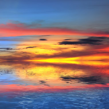 Dramatic sky reflection on coastal lagoon at sunset clipart