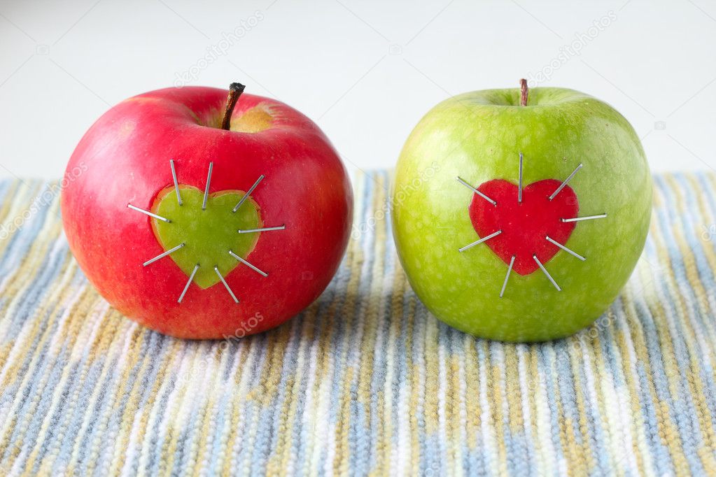 Green and red apple with a heart symbol