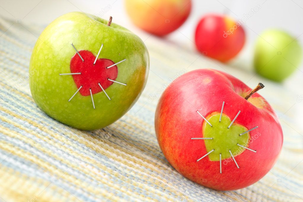 Green and red apple with a heart symbol