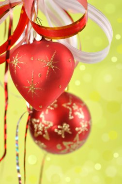 Christmas balls on a green background and abstract bokeh with s clipart