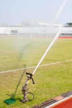 Nozzles are watering the field. clipart