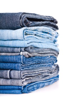 Stack of various jeans isolated on white background clipart