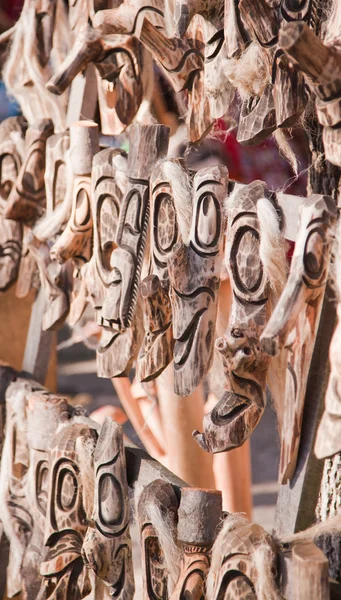 stock image Traditionally carved wooden masks for sale at a souvenir store in Romania.