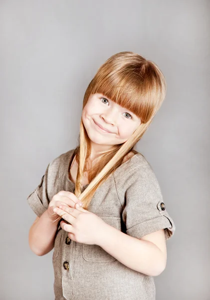 Little Girl Holding Her Hair Smiles — Stock Photo, Image