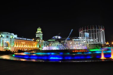 Kiev station and fountain Rape of Europe in Moscow at night. clipart