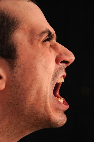 Stock image Studio photo of a angry man on black background