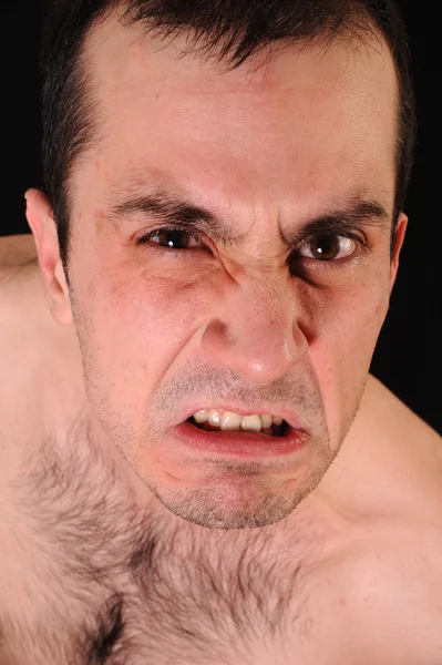 stock image Close up studio photo of a angry man on black background