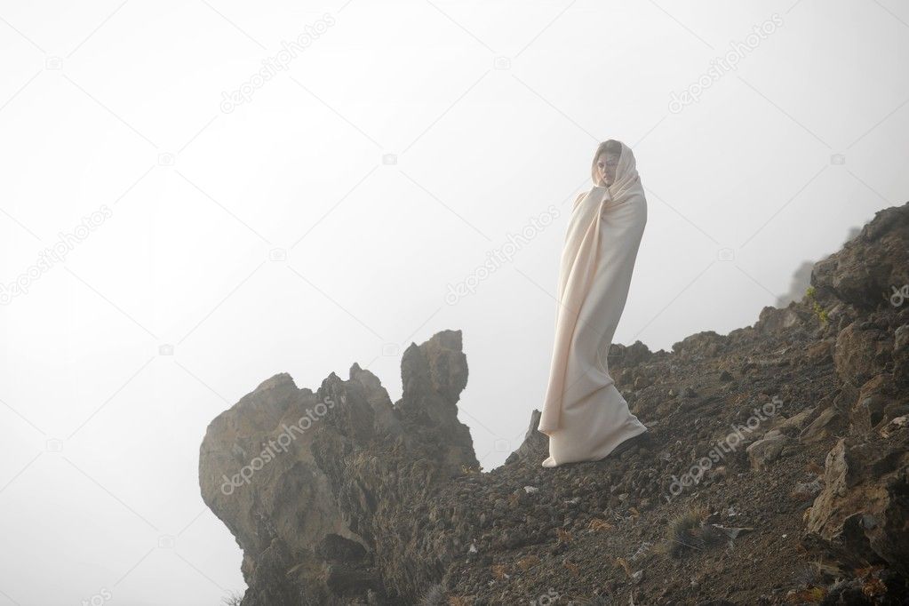 The girl shrouded in a cloud, it is high in mountains, early in the morning.