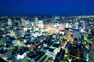 Sendai train station by night panoramic view clipart